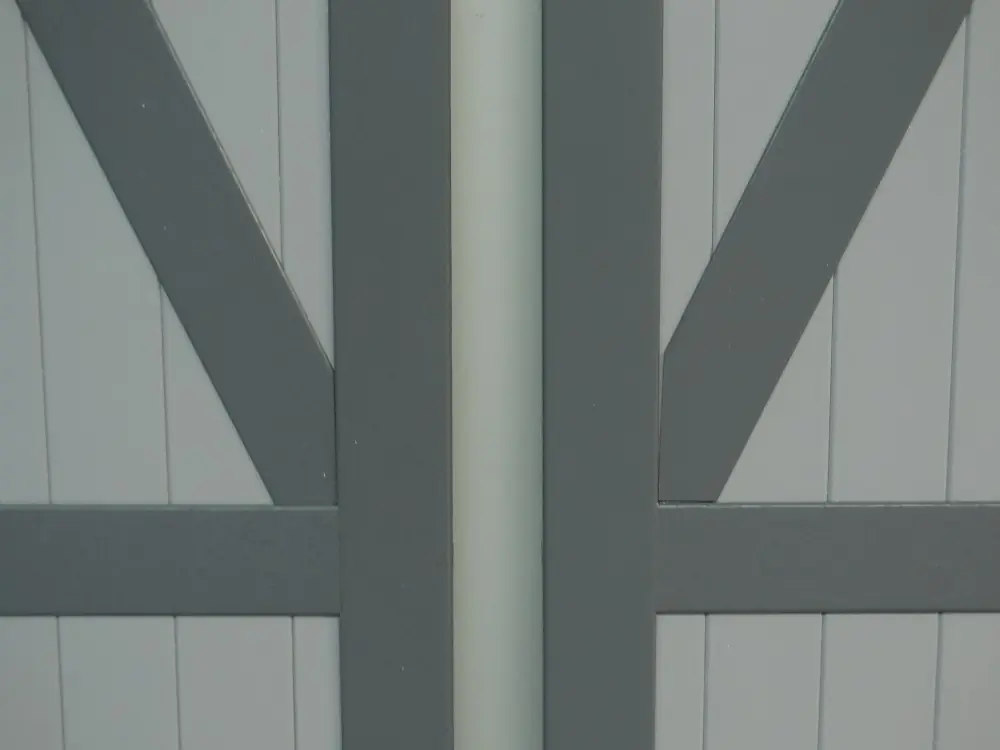 Detail van PVC Z-luik met verticale planchetten en opgekleefde diagonale sierlijst in grijs en wit – productdetail Ventinella